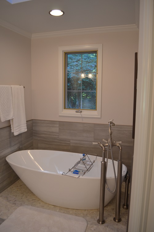 A beautiful sitting tub in a tile bathroom